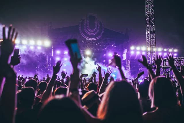 Performer on stage with orange lighting